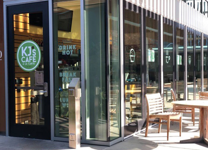 Students sitting outside and inside a cafe area