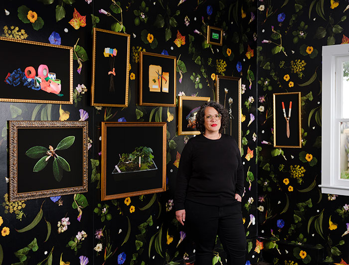 female in room with photographs on wall