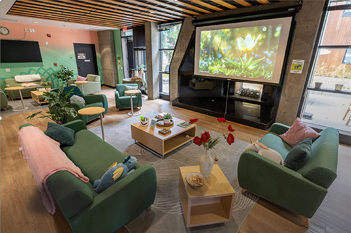 Female student resting on massage chair interior layout of the wellness lounge