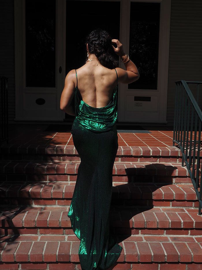 Women in emerald dress on brick steps