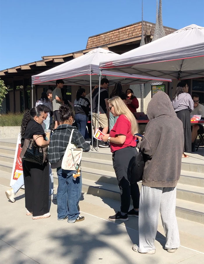 Group of people gathering outside Library