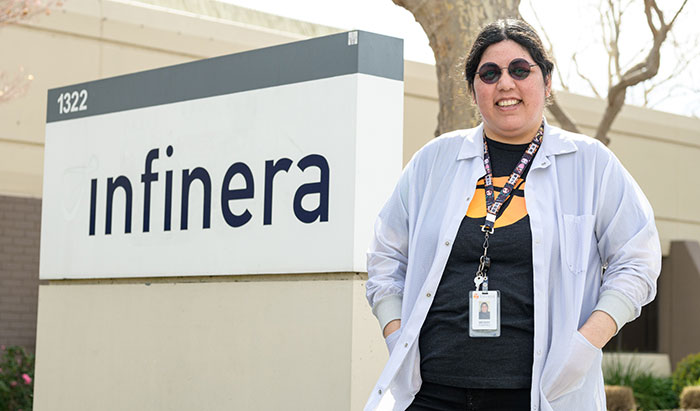 Merry Ramirez next to Infinera Building sign