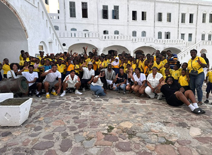 Large group of students in Ghana in front of building