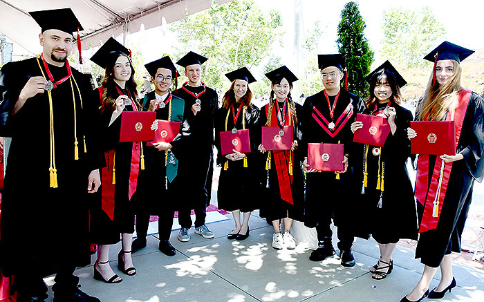 Large group of students holding medals