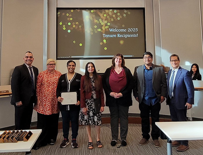 Group of 4 faculty with 3 administrators