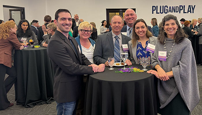 Group of colleagues standing at a tall round table